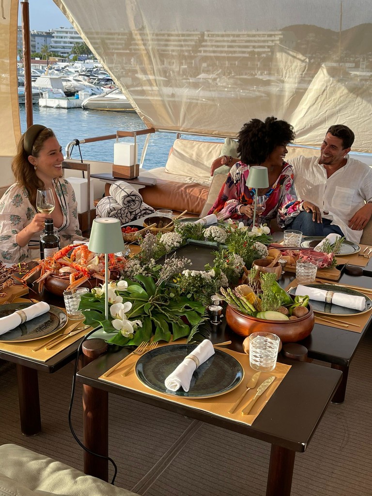 Private yacht dining with guests and a fully styled table